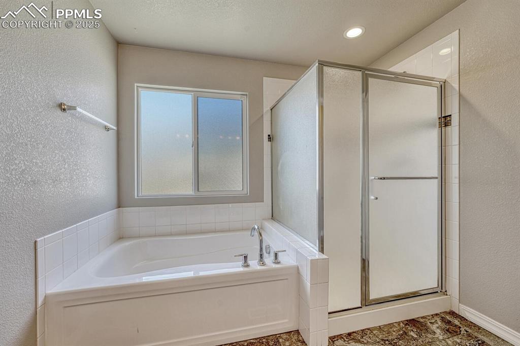 Image 14 of 45: Unwind in style in the primary bathroom, featuring a spa-inspired shower st