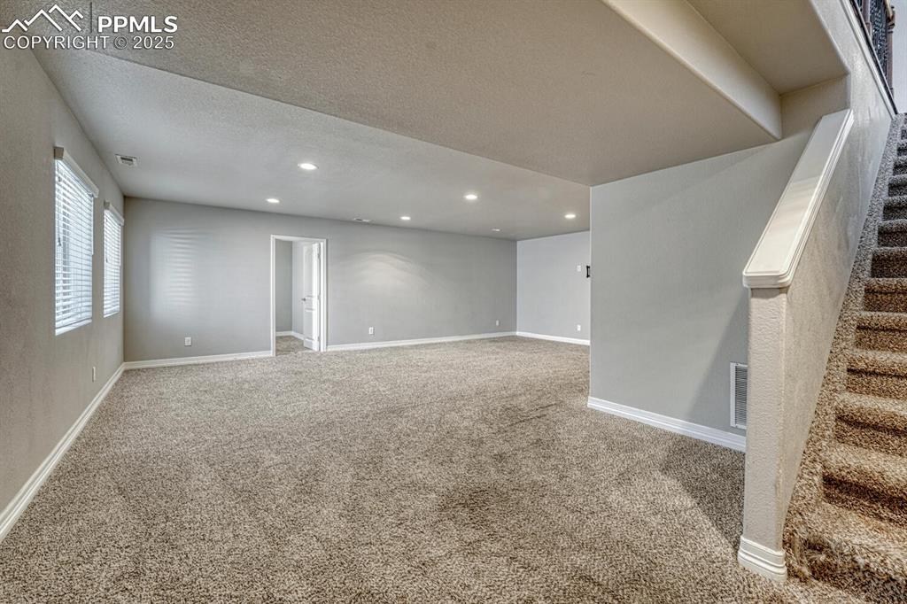 Image 19 of 45: Step into our inviting living room, featuring soft carpet floors, a texture