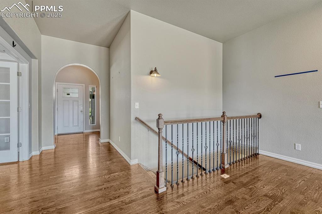 Image 2 of 45: A beautifully designed hallway boasts stunning wood floors and an elegant u