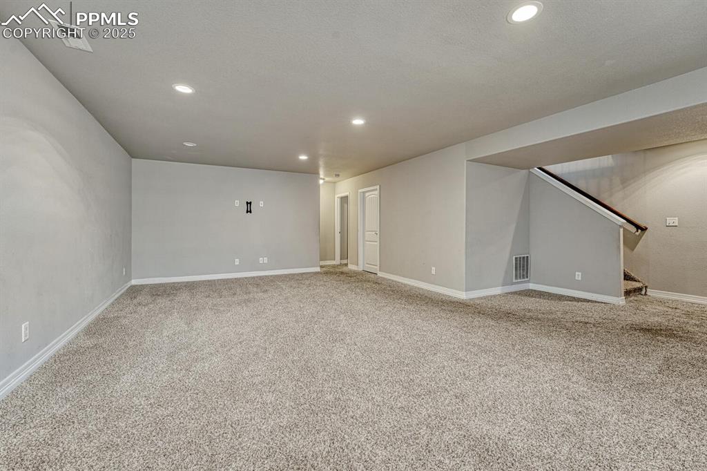Image 21 of 45: Step into our inviting living room, featuring soft carpet floors, a texture