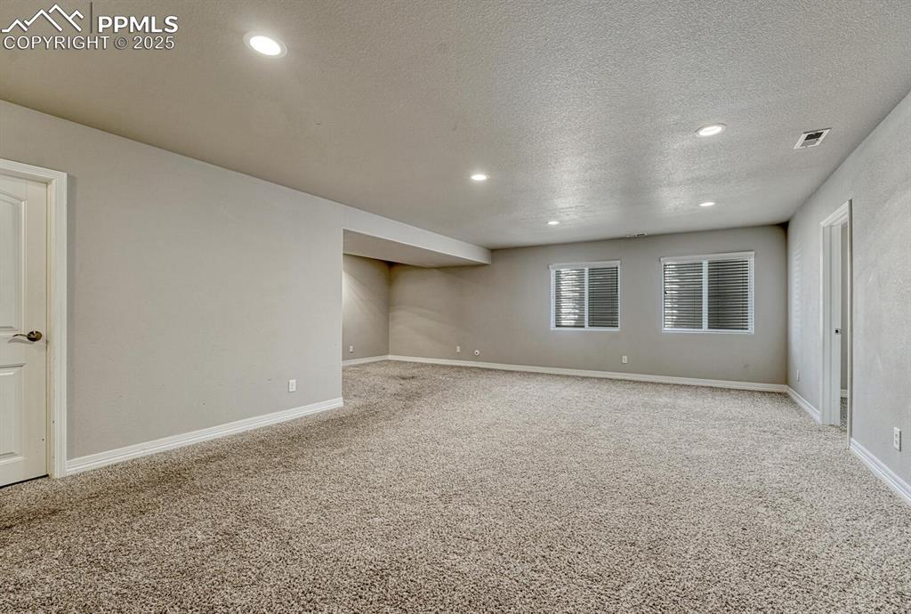 Image 22 of 45: Step into our inviting living room, featuring soft carpet floors, a texture