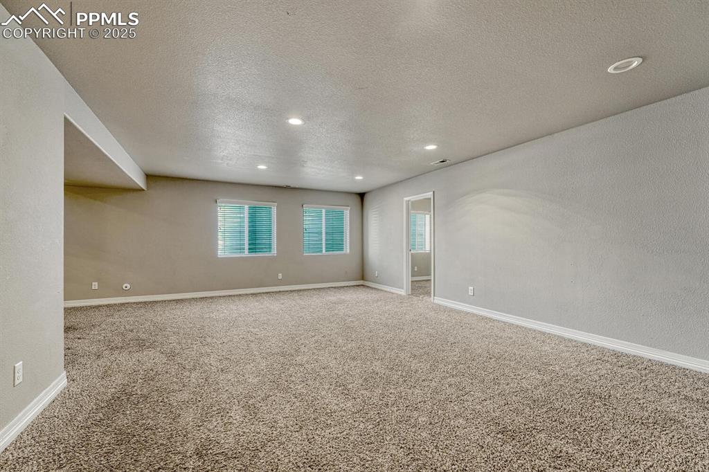 Image 23 of 45: Step into our inviting living room, featuring soft carpet floors, a texture