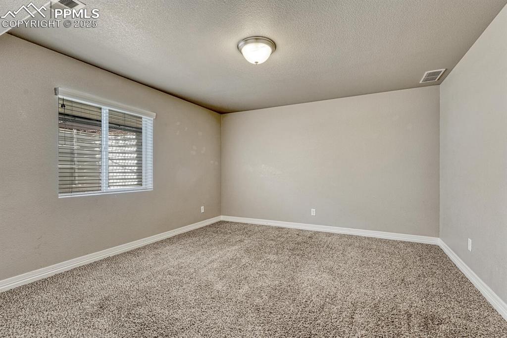 Image 25 of 45: A carpeted spare room with baseboards offers endless possibilities for tran