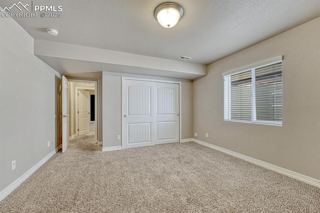 Image 26 of 45: Discover the possibilities in this spare bedroom, complete with a closet, s