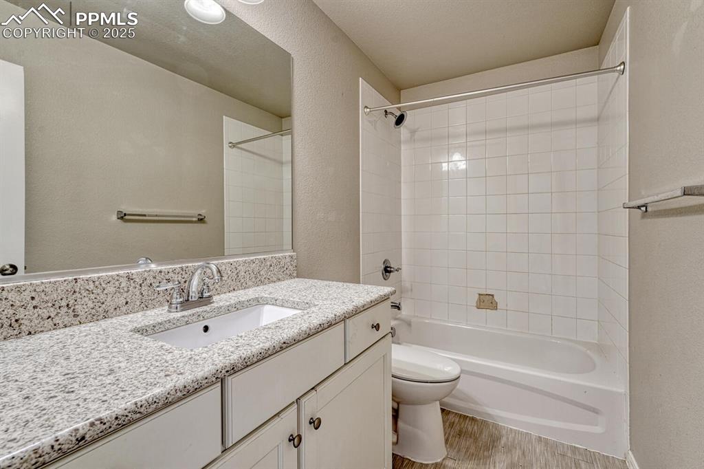 Image 3 of 45: Bathroom featuring a vanity, shower/washtub combination, hardwood floors, a