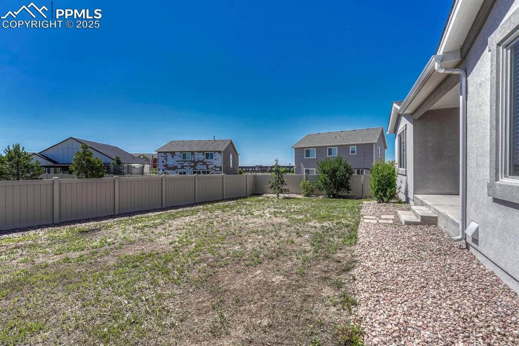 Image 32 of 45: Enjoy the perfect blend of seclusion and scenery in a fenced backyard with 