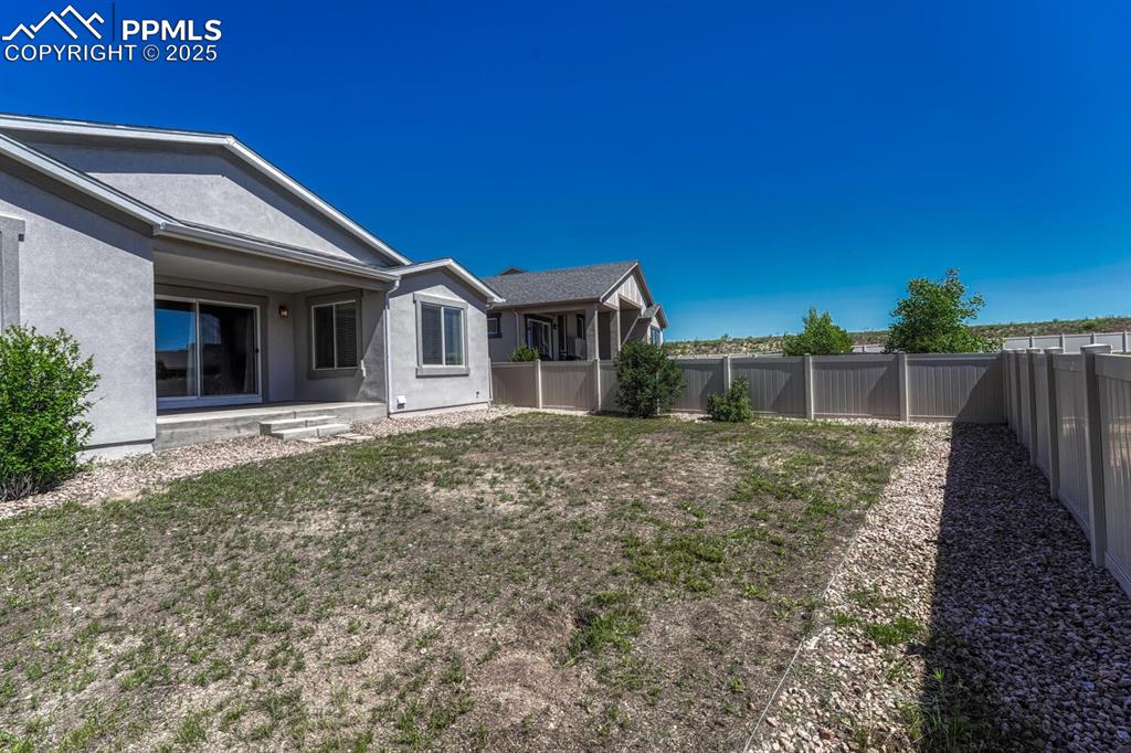 Image 33 of 45: Enjoy the perfect blend of seclusion and scenery in a fenced backyard with 