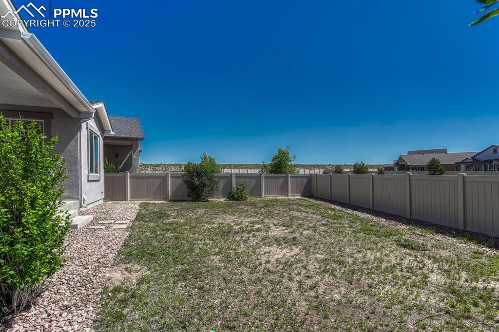 Image 34 of 45: Enjoy the perfect blend of seclusion and scenery in a fenced backyard with 