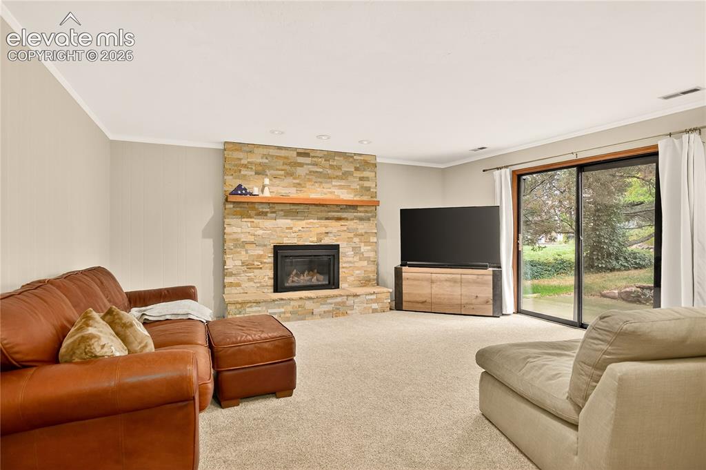 Image 15 of 21: Family room walk-out & fireplace
