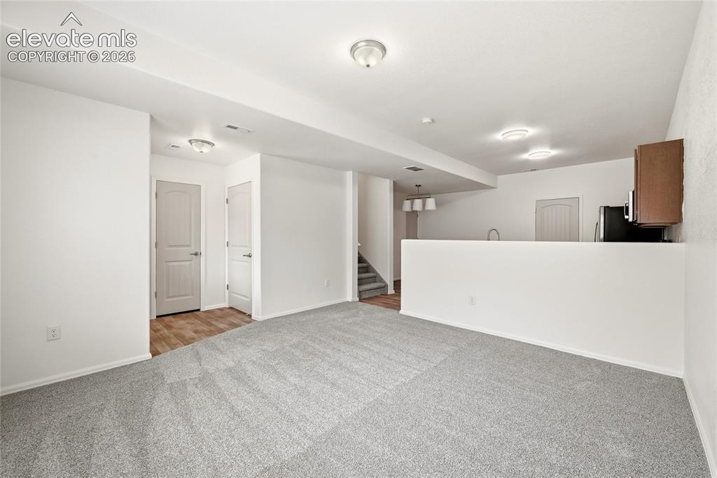 Image 11 of 44: Spacious lower-level area with light gray carpeting