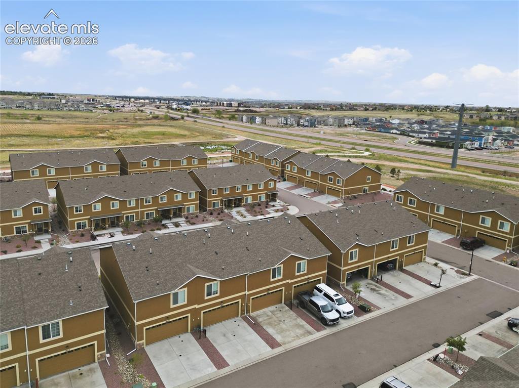 Image 40 of 44: An aerial perspective of a community featuring multi-level townhomes with b