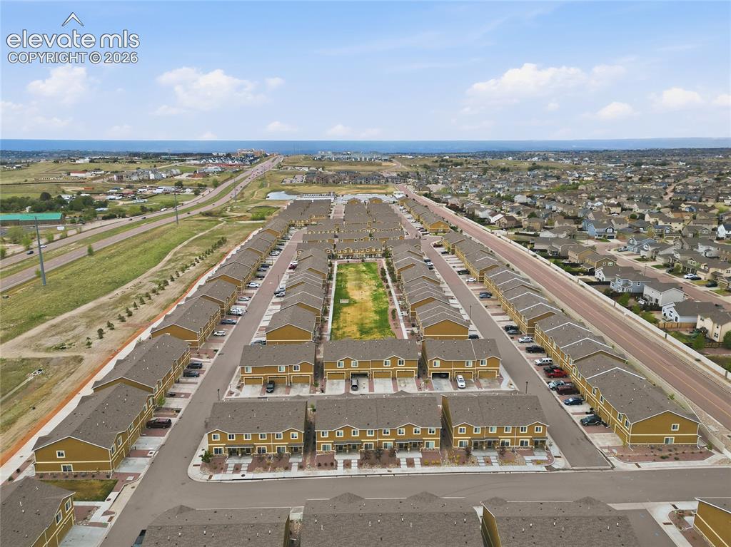Image 41 of 44: Aerial perspective showcasing a community of multi-story residences with ta