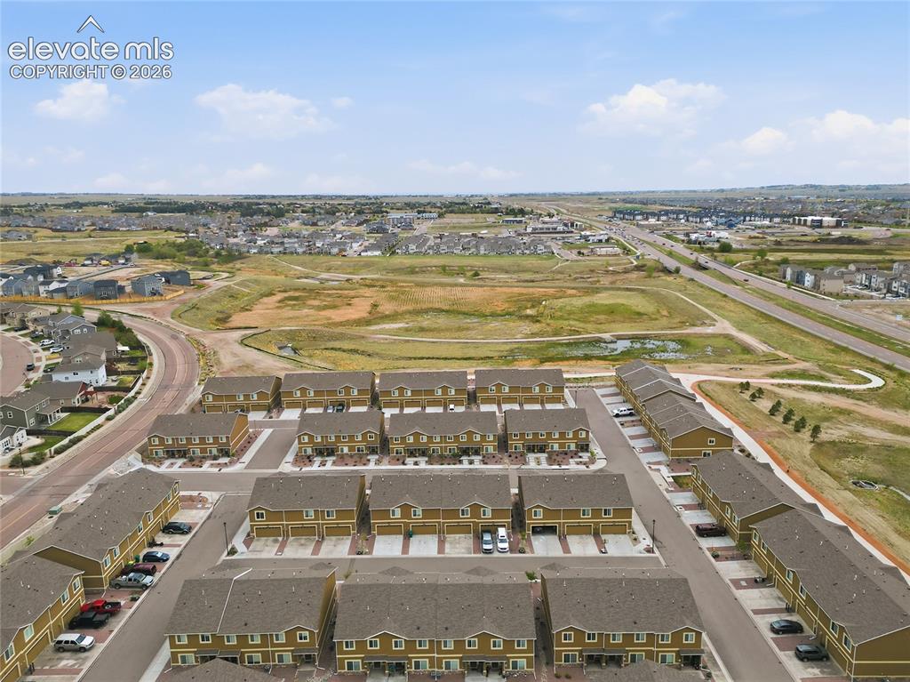 Image 43 of 44: Aerial perspective showcasing a community of multi-story residences with at