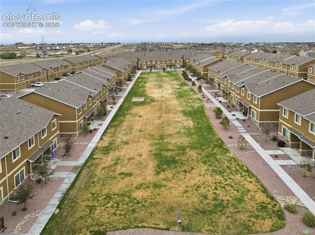 Image 44 of 44: Townhome community featuring a central green space