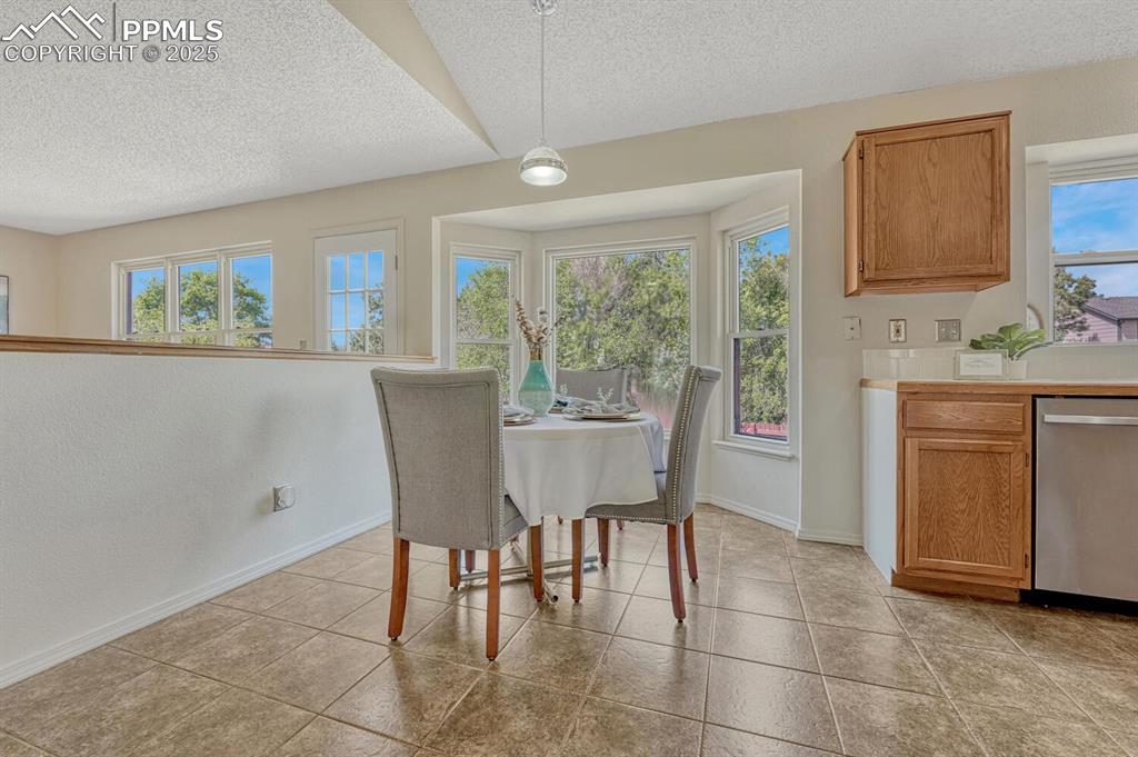 Image 12 of 40: The Dining Area has bay windows with views of the backyard. 
