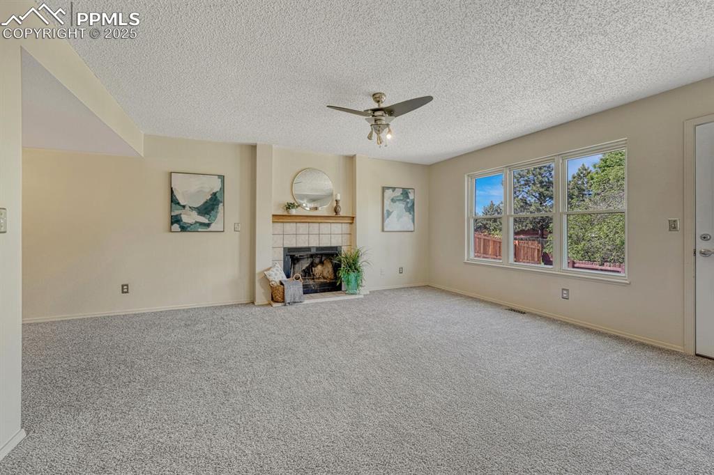 Image 14 of 40: The Family Room offers a lighted ceiling fan, and wood-burning fireplace, p