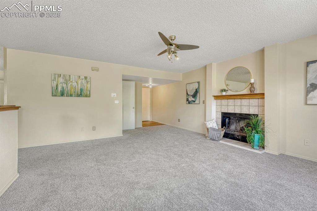 Image 19 of 40: Cozy wood-burning fireplace with tile surround to warm up to on chilly Colo