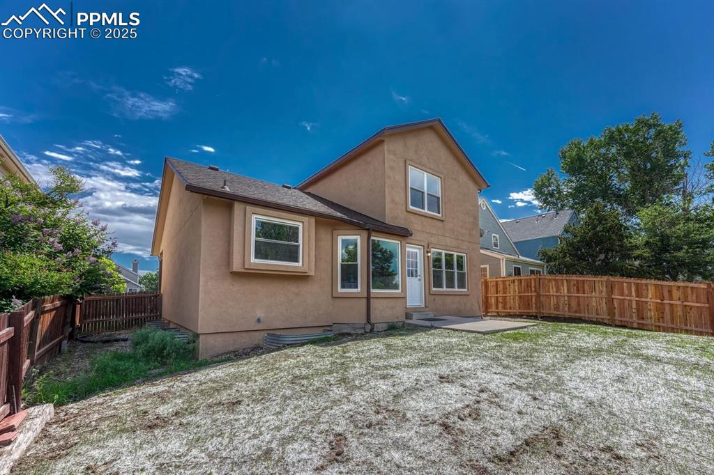 Image 35 of 40: The fenced backyard offers auto sprinklers, a new side fence, concrete pati