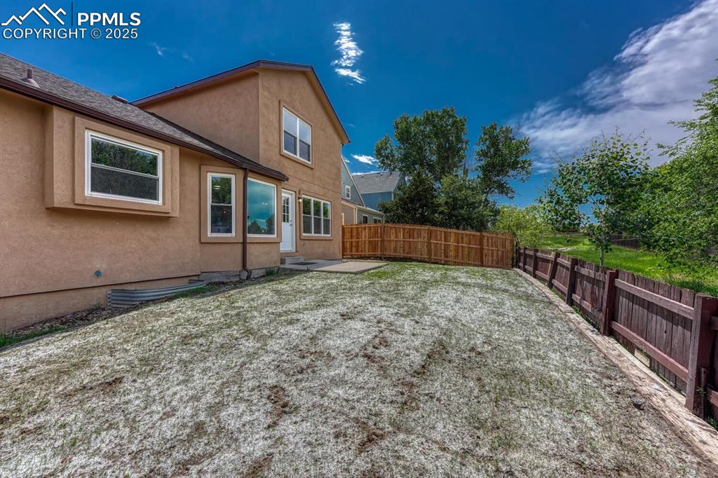 Image 37 of 40: The yard backs to open space with mature trees and mountain views.