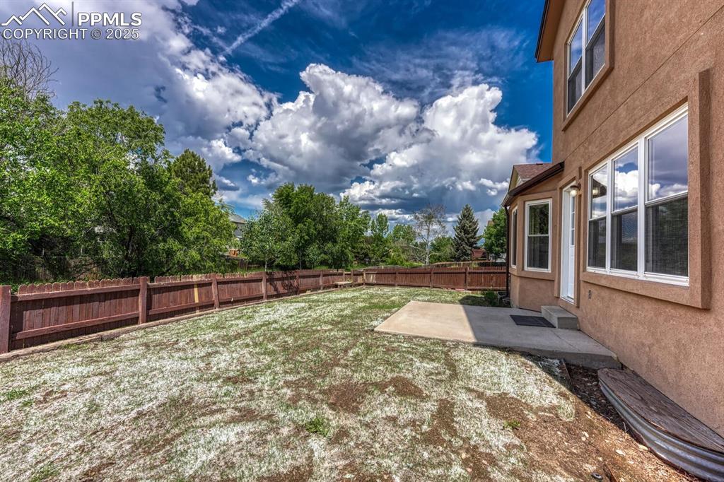 Image 38 of 40: Backyard patio and easy to maintain landscaping with auto sprinklers.