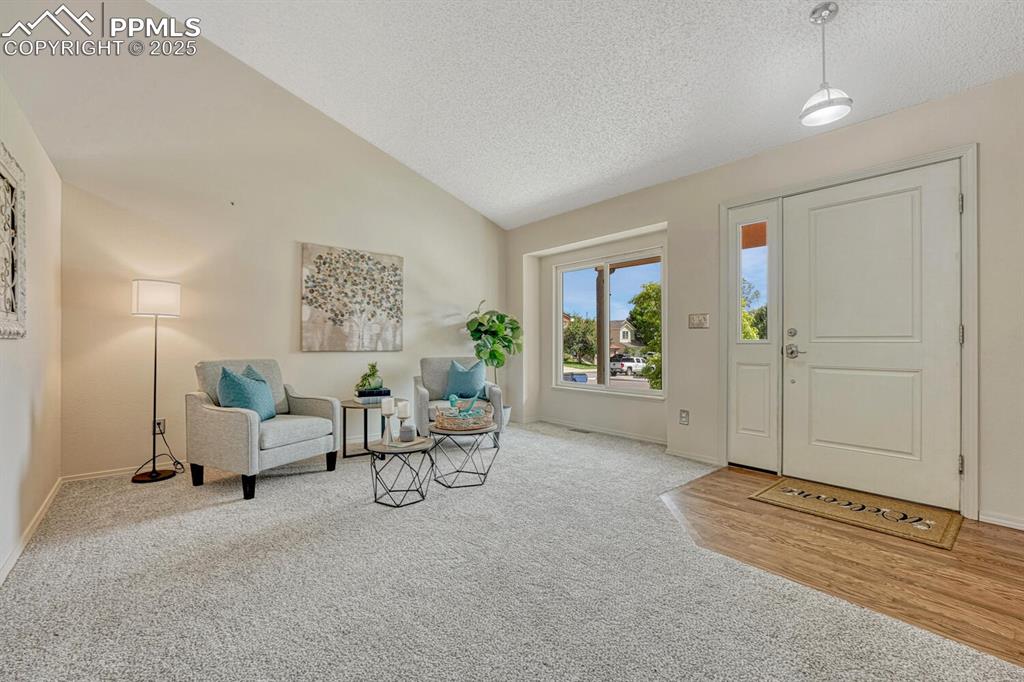 Image 4 of 40: The Front Entry opens into the vaulted Living Room.