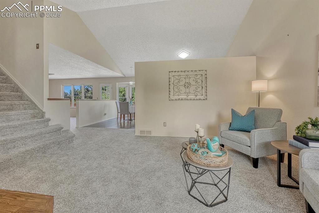 Image 6 of 40: The spacious Living Rm enjoys a front yard view & flows seamlessly into the