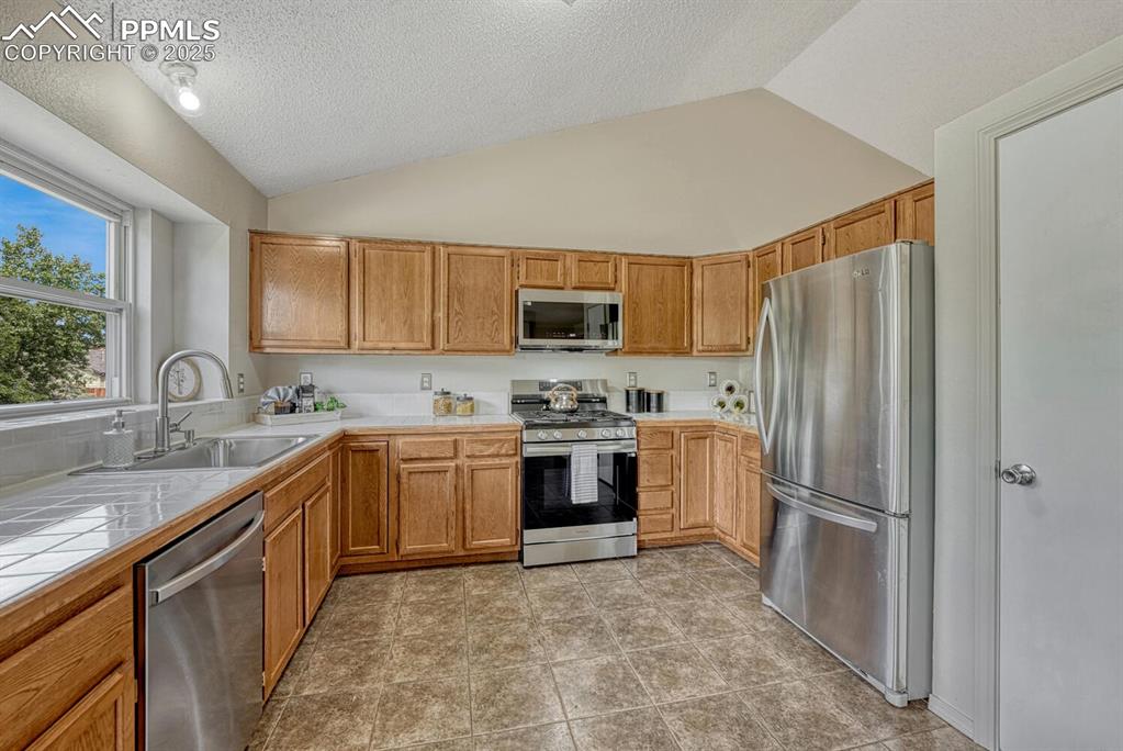 Image 8 of 40: Spacious Kitchen with ample cabinetry and counterspace for storage and easy