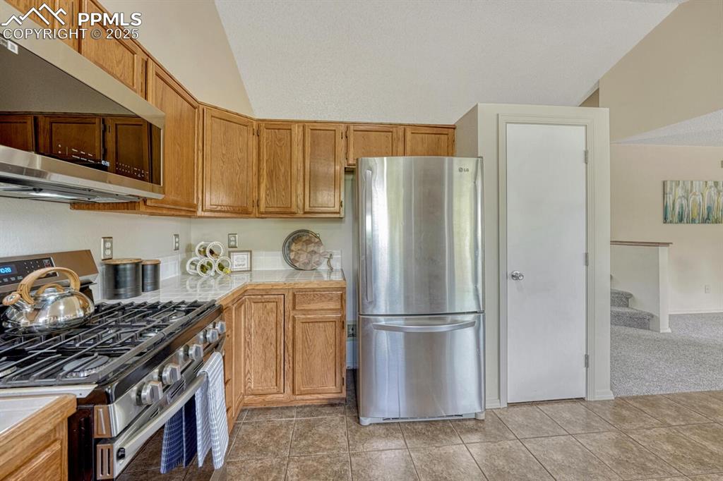 Image 9 of 40: Newer Appliances include a gas range oven, microwave, dishwasher, and refri