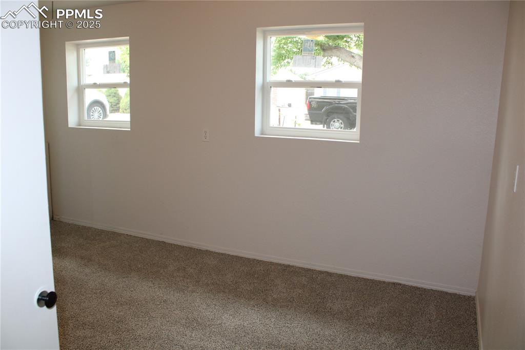 Image 13 of 35: Carpeted bedroom featuring healthy amount of natural light
