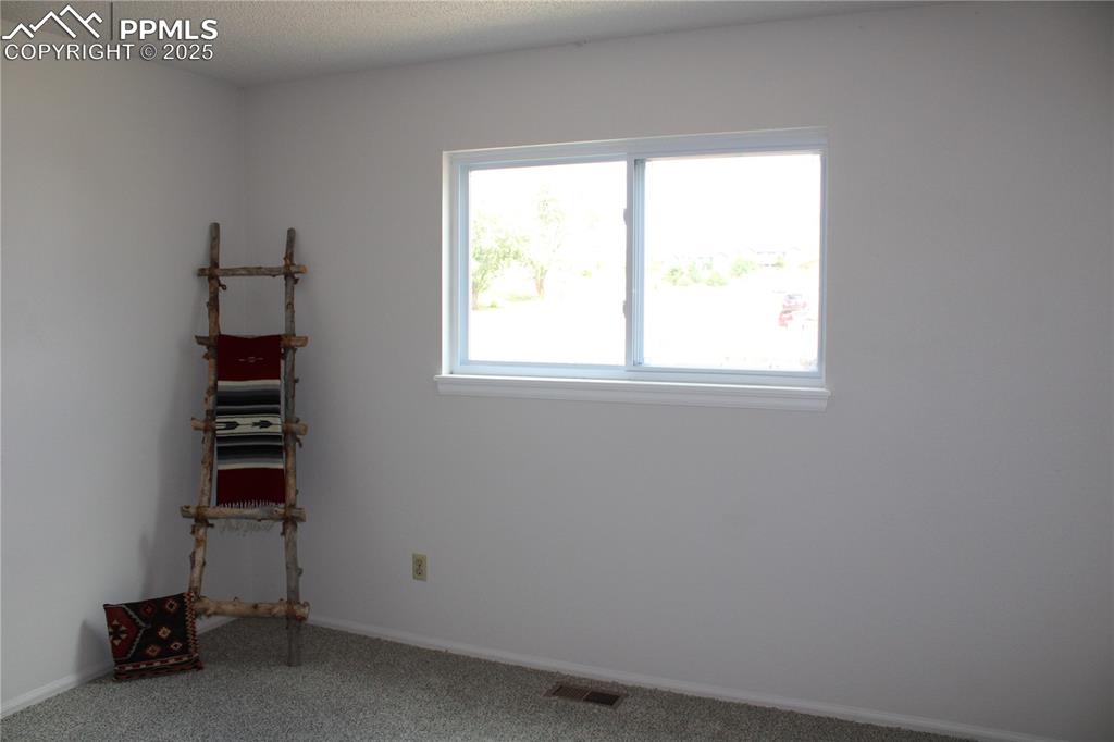 Image 21 of 35: Carpeted bedroom with baseboards