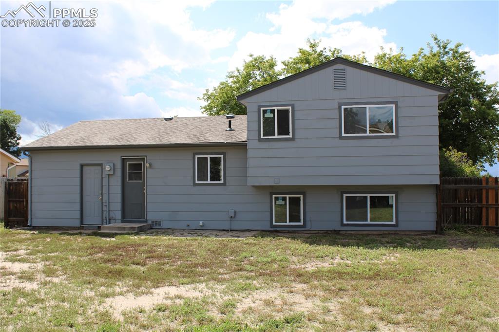 Image 26 of 35: Rear view of house with a shingled roof