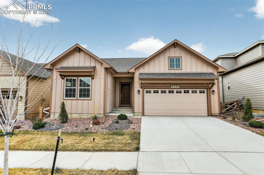 Image 1 of 44: Contemporary ranch-style facade with board and batten siding