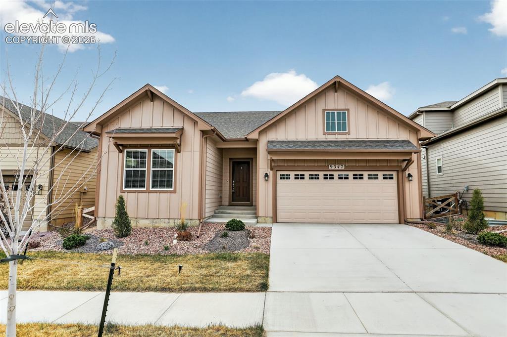 Image 1 of 49: Contemporary ranch-style facade with board and batten siding