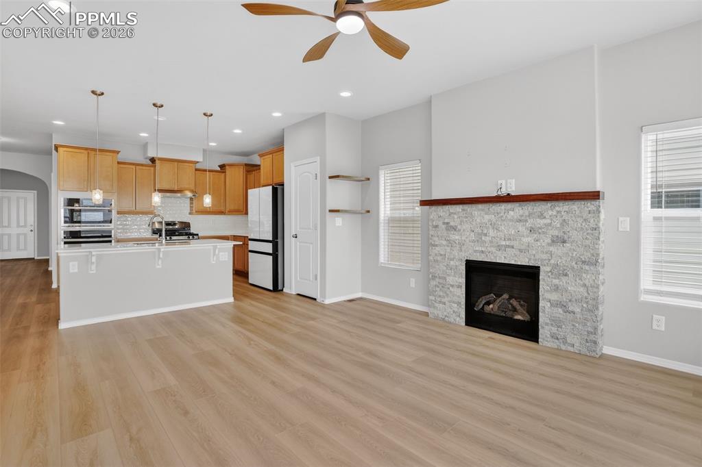 Image 10 of 44: Kitchen island featuring a double-basin sink, stainless steel faucet, and i