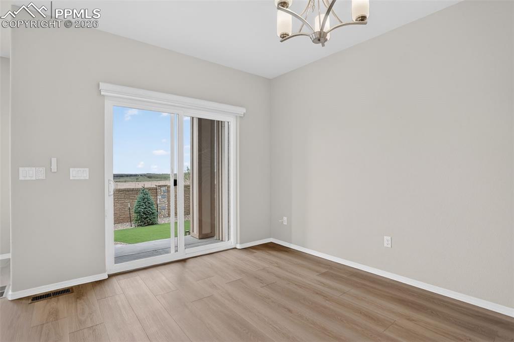 Image 12 of 44: Open-concept living space featuring wood-finish flooring, a contemporary fi