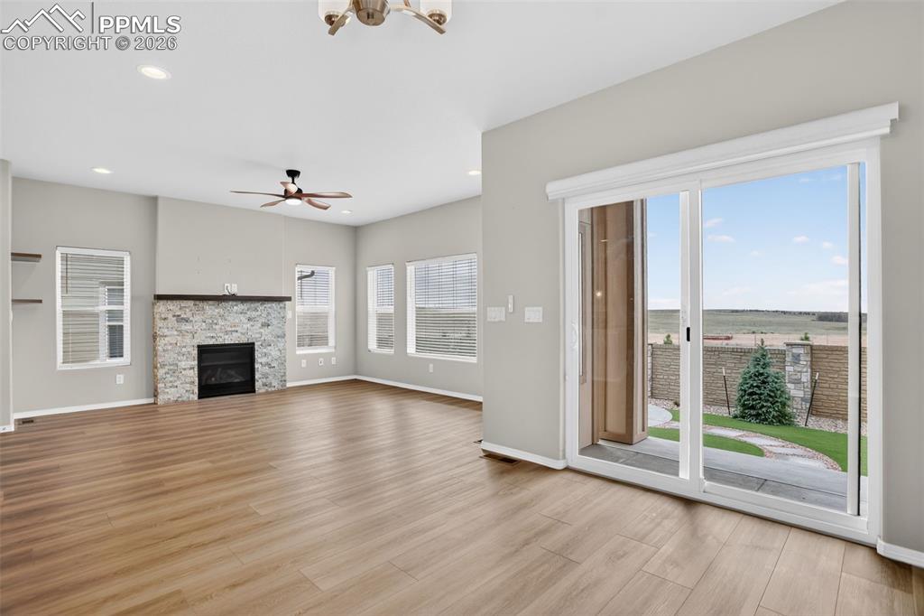 Image 13 of 44: Open-concept living space featuring wood-finish flooring, recessed lighting