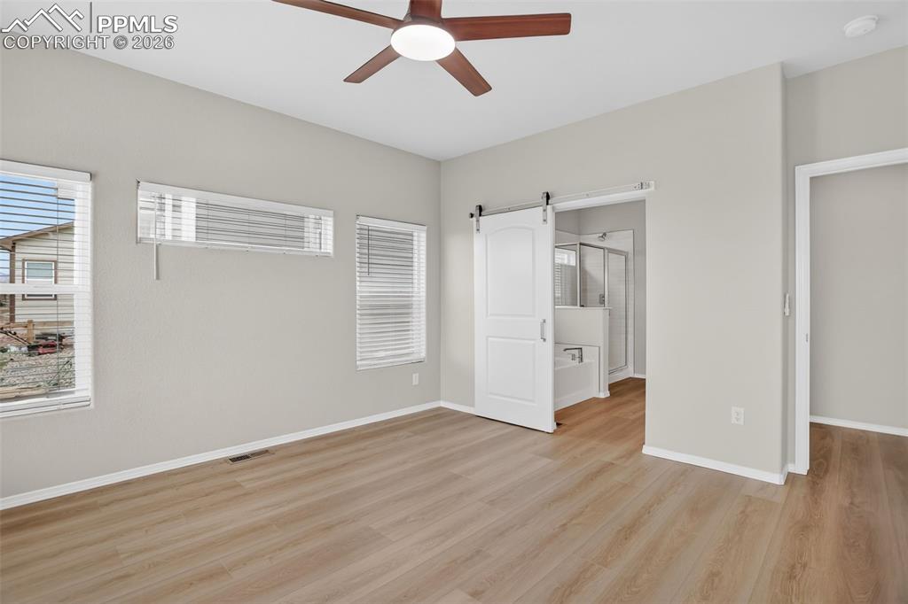 Image 19 of 44: Utility room featuring light wood-finish flooring, light neutral wall paint