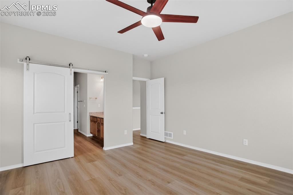 Image 22 of 44: Bathroom with wood-finish flooring, dual vanity featuring granite counterto