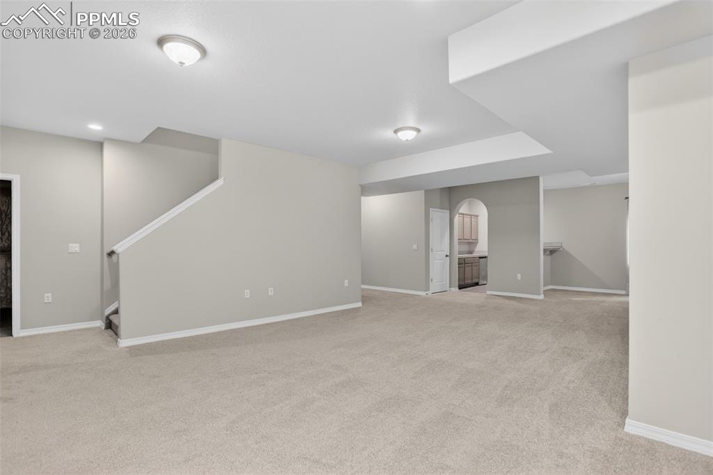 Image 25 of 44: Expansive closet space featuring wood-finish flooring, light gray wall pain