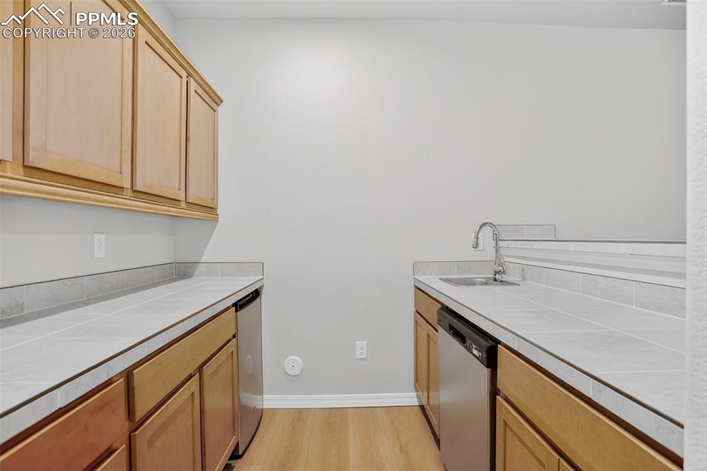 Image 26 of 44: Spacious room featuring light wood-finish flooring, neutral wall paint, and