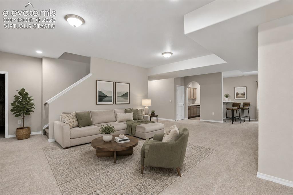 Image 27 of 49: Spacious main living area featuring neutral carpeting, recessed lighting, a