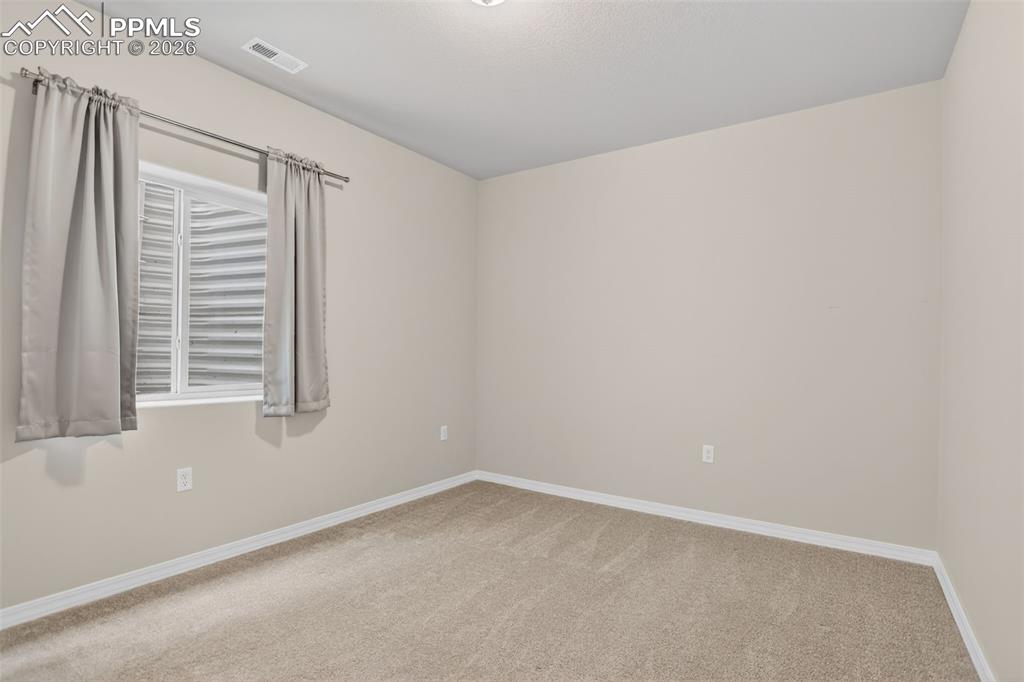 Image 29 of 44: Spacious room featuring light gray carpeting, neutral wall finishes, recess