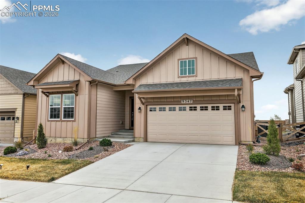 Image 3 of 44: Siding exterior with board-and-batten gables, an attached garage, a concret