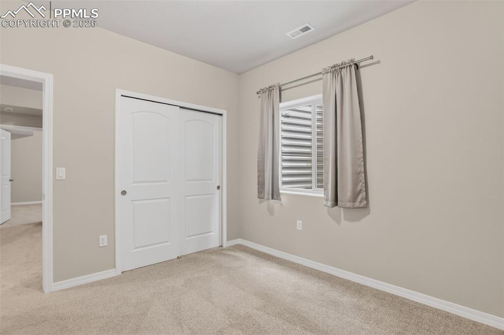 Image 30 of 44: Neutral-toned wall paint throughout, complemented by light-colored carpet f