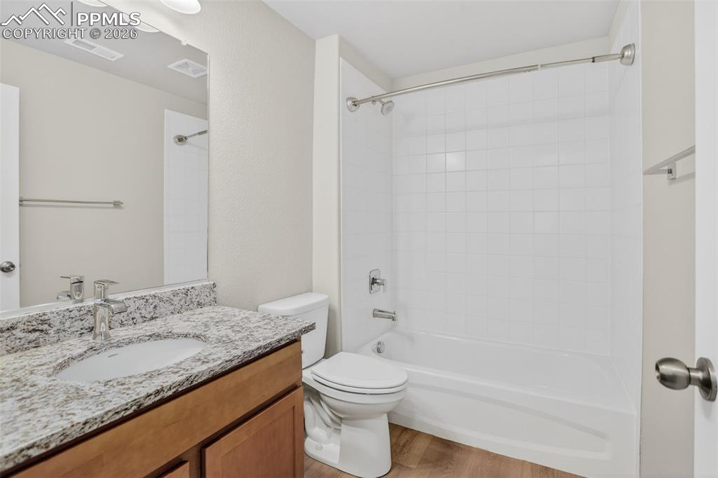 Image 31 of 44: Neutral-toned room featuring a single window with a privacy screen, light b