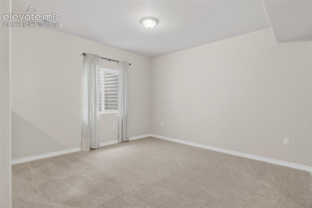 Image 32 of 49: Neutral-toned wall paint throughout, complemented by light-colored carpet f