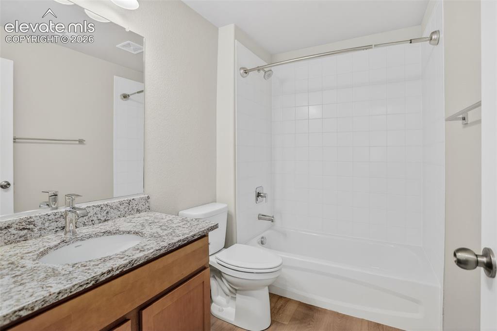 Image 36 of 49: Bathroom featuring a single vanity with a granite-style countertop, undermo