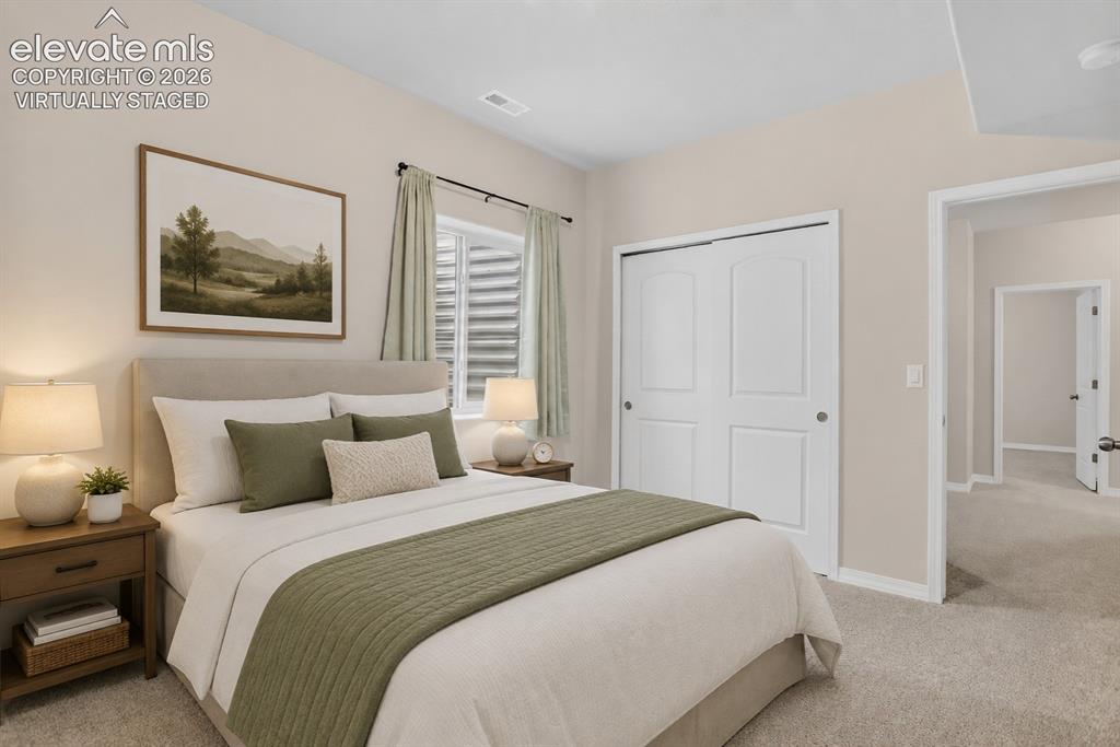 Image 37 of 49: Bedroom featuring light neutral wall tones and a window with horizontal bli