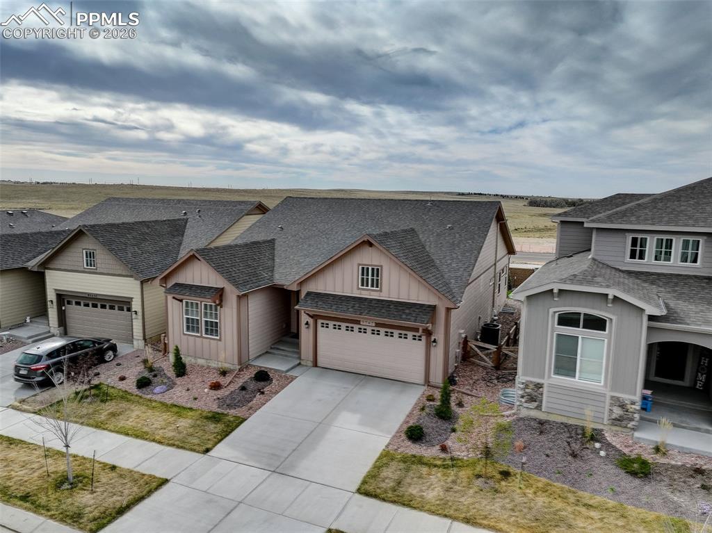 Image 40 of 44: Expansive backyard featuring a circular concrete patio, artificial turf law