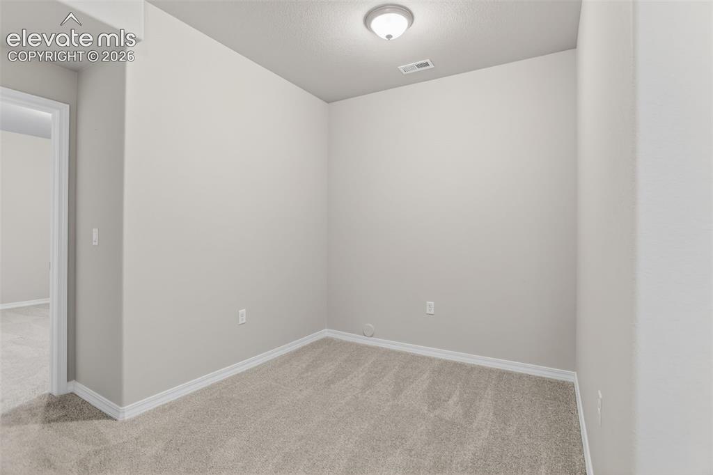 Image 41 of 49: Room featuring neutral-toned walls, light-colored carpet, white baseboards,